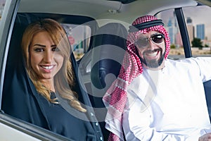 Arabian couple in a newely purchased car