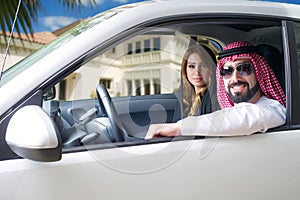 Arabian couple in a newely purchased car