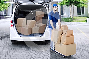 Arabian courier carrying packages with trolley