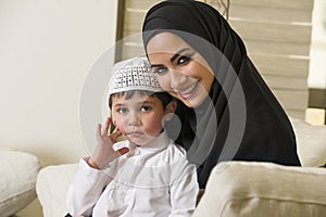 Arabian family, mother and son sitting on the couch