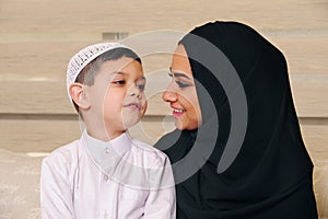 Arabian family, mother and son sitting on the couch