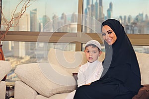 Arabian family, mother and son sitting on the couch in their living room