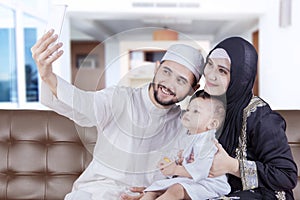 Arabian family taking selfie with smartphone