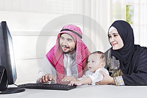 Arabian family using a computer at home