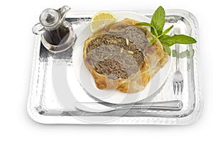 Arabian flatbread of beef with pine, `Lahme b ajeen` on white background