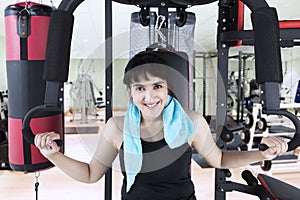 Arabian girl exercising with weight machine