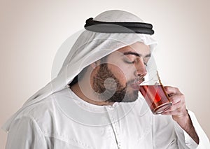 Arabian guy drinking tea / aroma tempting beverage photo