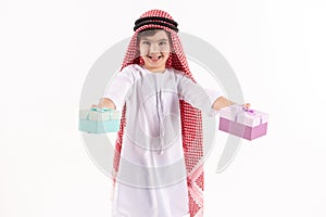 Arabian happy boy in keffiyeh presents gift boxes.