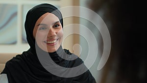 Arabian happy smiling businesswoman muslim islamic girl woman in hijab manager consultant saleswoman realtor talking