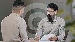 Arabian male financial consultant executive analysts expert lawyer man offer client customer insurance paperwork explain
