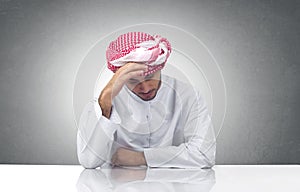Arabian man expressing sadness in his office