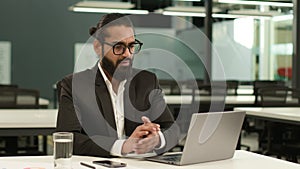 Arabian man Indian office worker at workplace table ethnic business employer entrepreneur guy male businessman typing