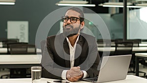 Arabian man Indian office worker at workplace table ethnic business employer entrepreneur guy male businessman typing