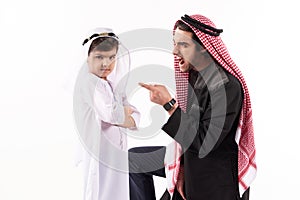 Arabian man in keffiyeh yells at son.