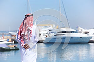 Arabian man looking at the yacht harbor