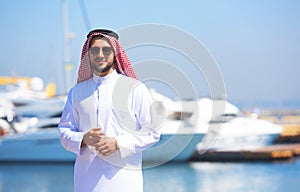 Arabian man looking at the yacht harbor