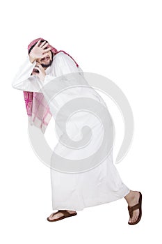 Arabian man running away from something