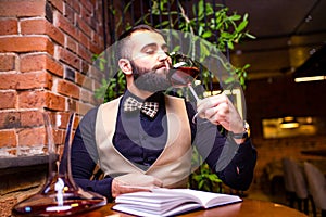 arabian man sommelier appreciating drink in lux hotel