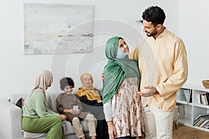 arabian man talking to muslim daughter