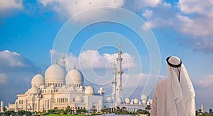 Arabian man watching Sheikh Zayed Grand Mosque in Abu-Dhabi, United Arab Emirates