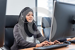 Arabian or Muslim woman works in a call center operator