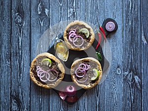 Arabian opened meat pies Sfiha on wooden board.