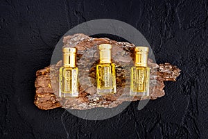 Arabian oud attar perfume essential oil in glass bottles, top view