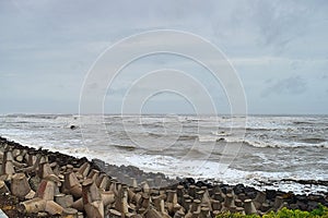 Arabian Sea or Indian Ocean with High Tide and Cloudy Sky & Rocky Beach at time of Vayu Cyclone - Devbhumi Dwarka, Gujarat, India