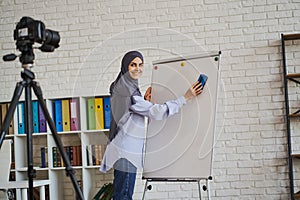 Arabian teacher recording a video with her lecture