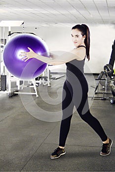 Arabian woman with ball in the fitness center