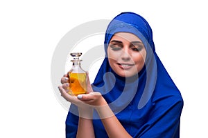 The arabian woman with bottle of perfume isolated on white