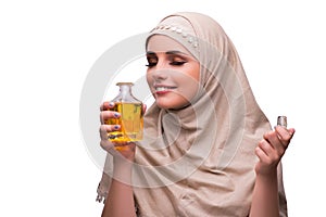 The arabian woman with bottle of perfume isolated on white