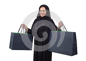 Arabian woman carrying shopping bags isolated on white
