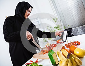 Arabian woman cooking in the kitchen