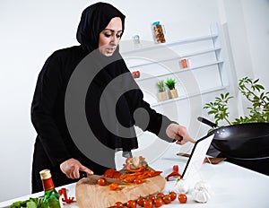 Arabian woman cooking in the kitchen