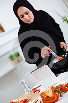 Arabian woman cooking in the kitchen