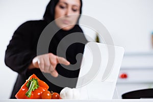 Arabian woman cooking in the kitchen