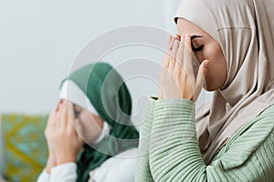 Arabian woman covering face while praying