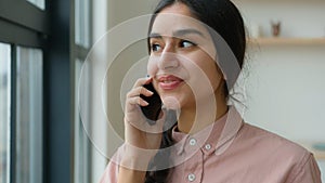 Arabian woman girl student talk mobile phone at home office sharing news talking cellphone female homeowner