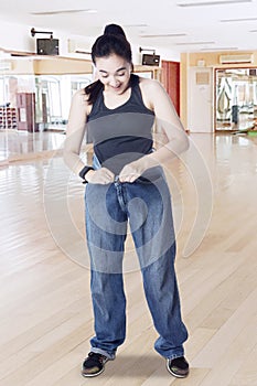 Arabian woman with old jeans in fitness center