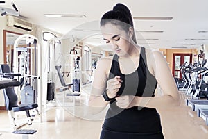 Arabian woman with smartwatch in the fitness center
