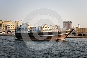 Arabian wooden traditional boat on water in the river in the old Dubai area.