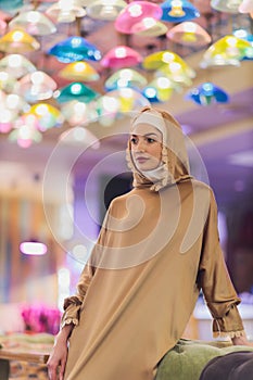 Arabian young muslim woman sitting in a cafe.