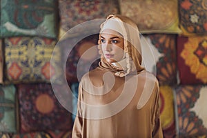 Arabian young muslim woman sitting in a cafe.