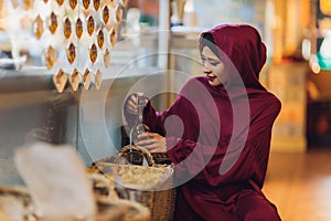 Arabian young muslim woman sitting in a cafe.