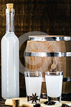 Arabic alcohol drink Raki with anis on wooden background.Turkish and Greek Traditional aperitif arak, Ouzo. Distilled drink with