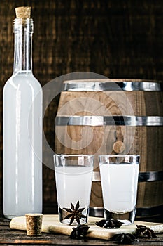 Arabic alcohol drink Raki with anis on wooden background.Turkish and Greek Traditional aperitif arak, Ouzo. Distilled drink with