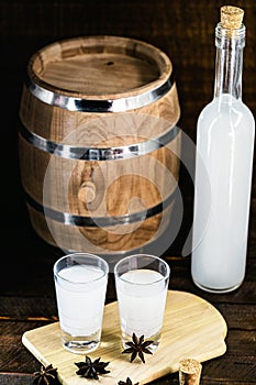 Arabic alcohol drink Raki with anis on wooden background.Turkish and Greek Traditional aperitif arak, Ouzo. Distilled drink with