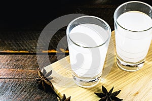 Arabic alcohol drink Raki with anis on wooden background.Turkish and Greek Traditional aperitif arak, Ouzo. Distilled drink with