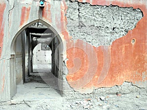 Arabic arch gate in grey orange wall in Taghjijt oasis